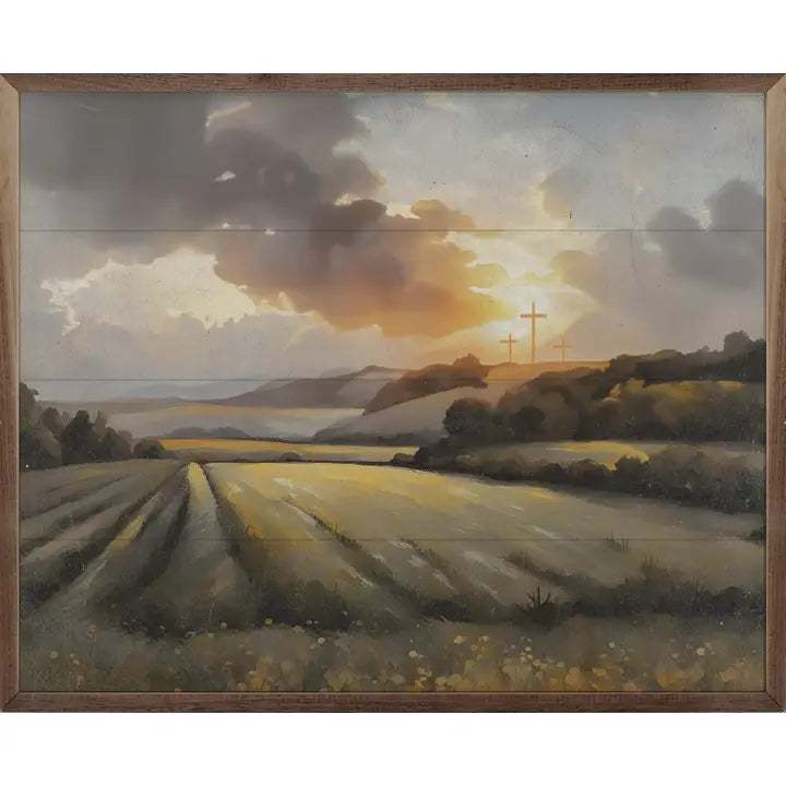Framed oil painting of golden fields at sunset with three crosses on a hill