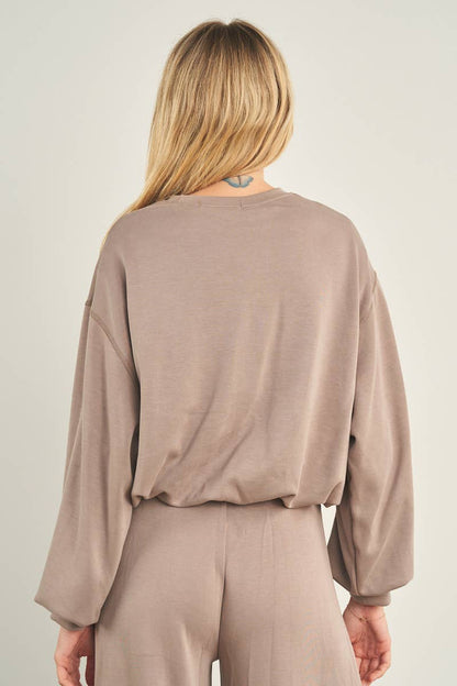 ANWND taupe cropped crewneck sweatshirt with oversized balloon sleeves, back view