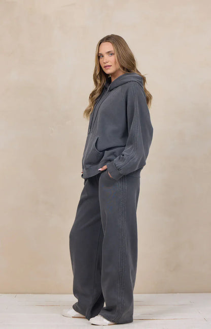 Women's charcoal wide-leg sweatpants with contrast stripe detail and relaxed fit
