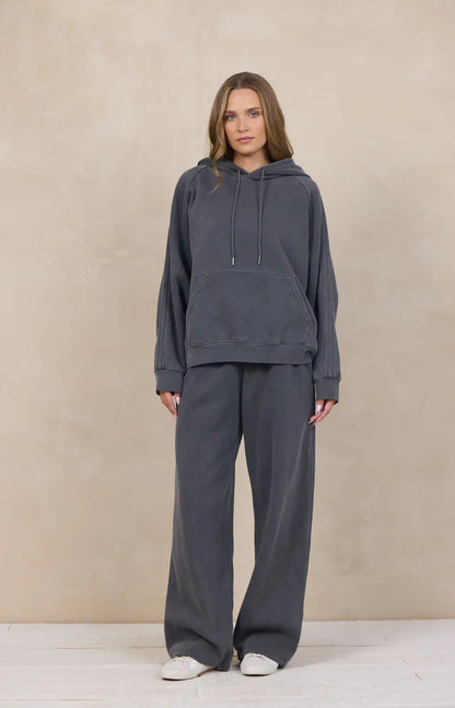 Wide-leg cement gray sweatpants with subtle stripe detail, paired with matching hoodie