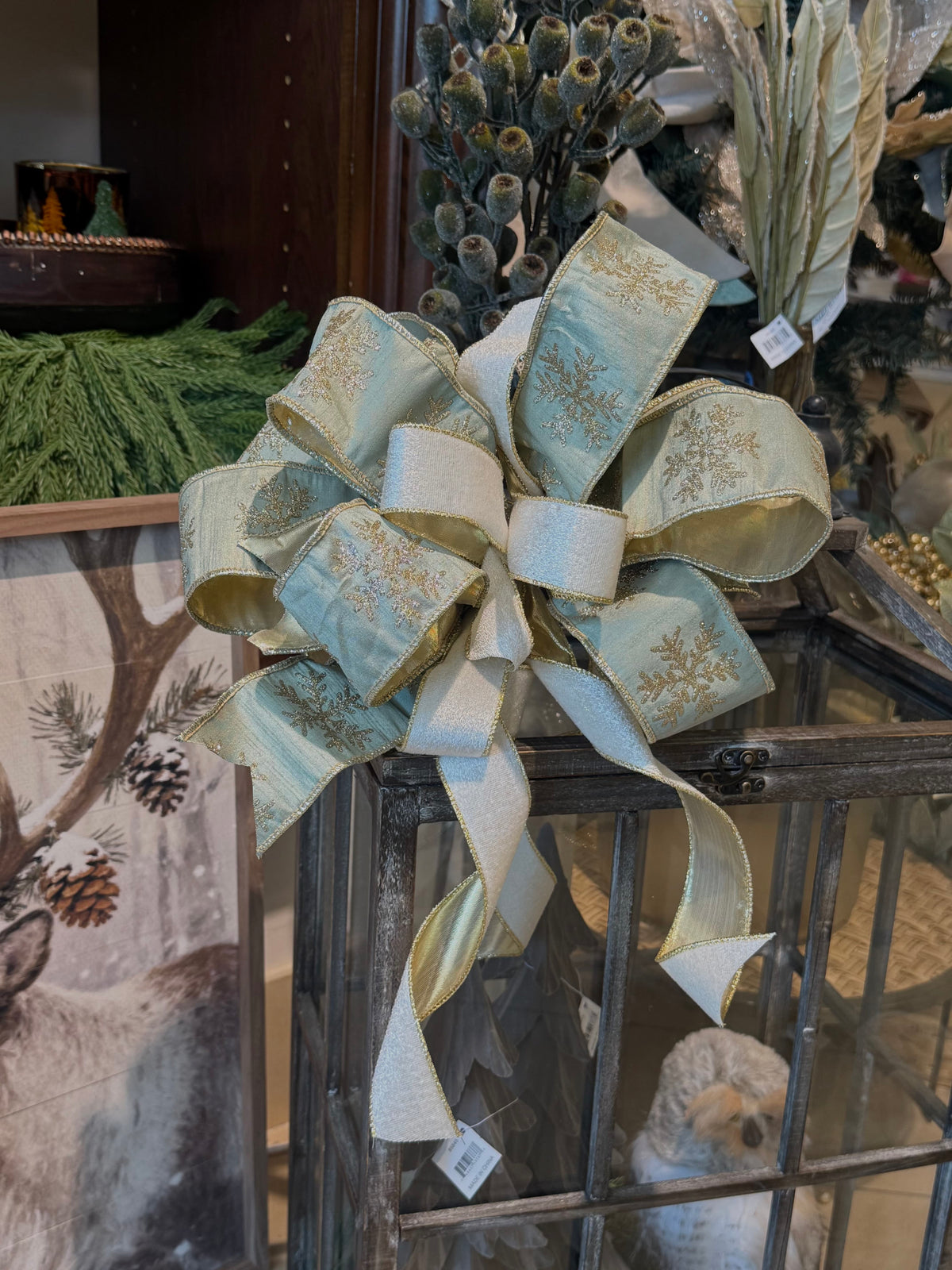 Gold and sage green wired ribbon bow with glitter snowflake pattern, layered loops