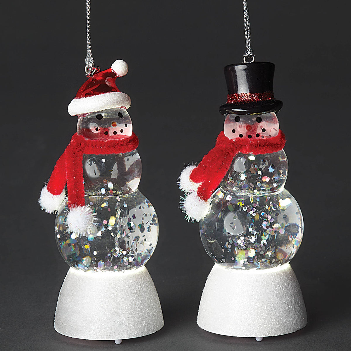 Two LED glass snowman ornaments with red scarves, Santa hat and top hat styles