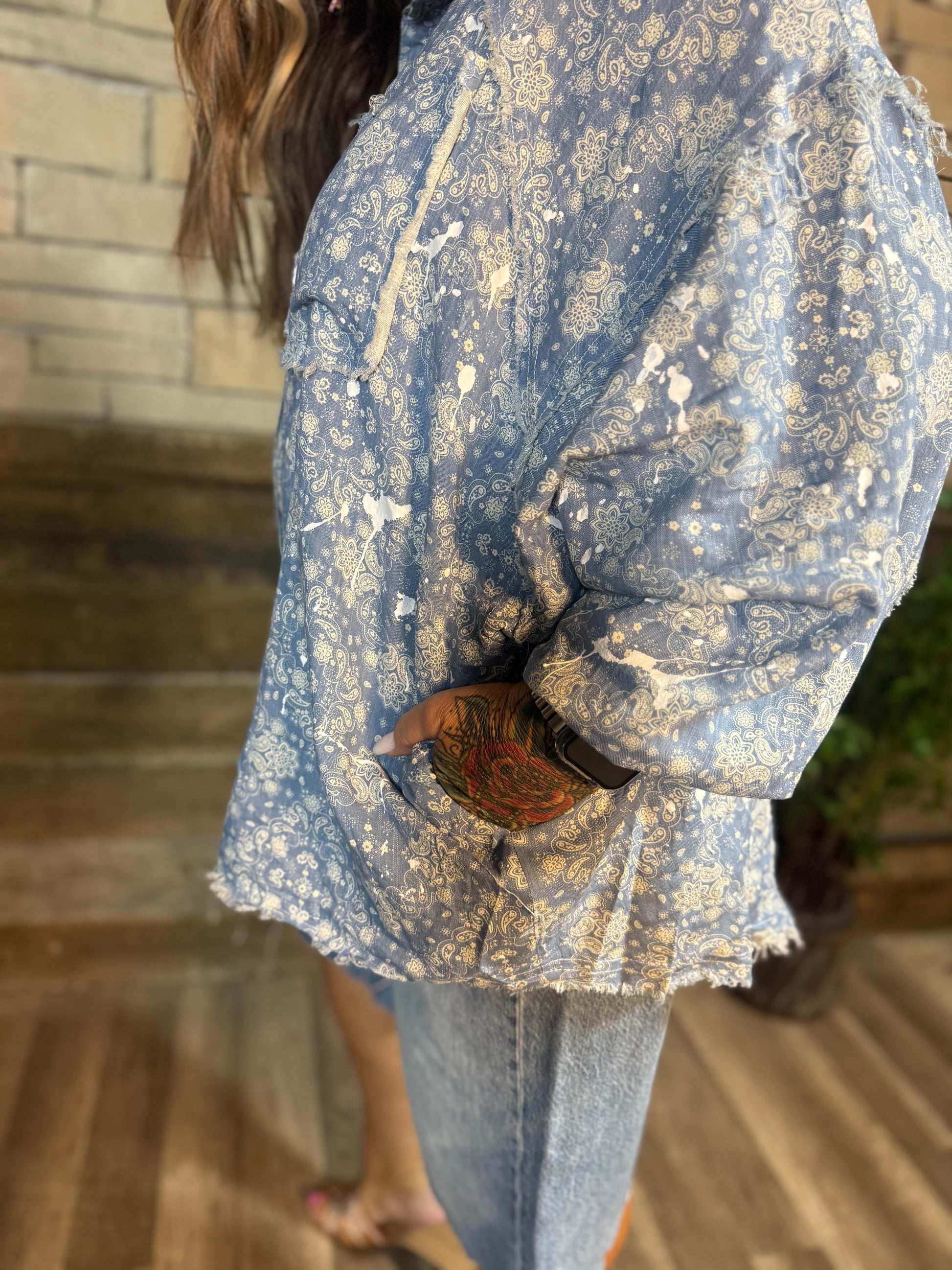 Blue paisley distressed button down shirt with paint splatter detail and frayed hem
