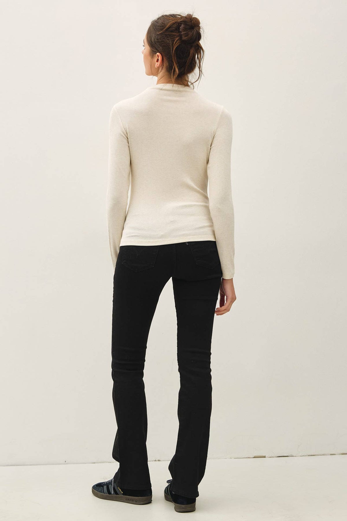 Cream ribbed mockneck long sleeve knit top, slim fit, worn with black flare pants