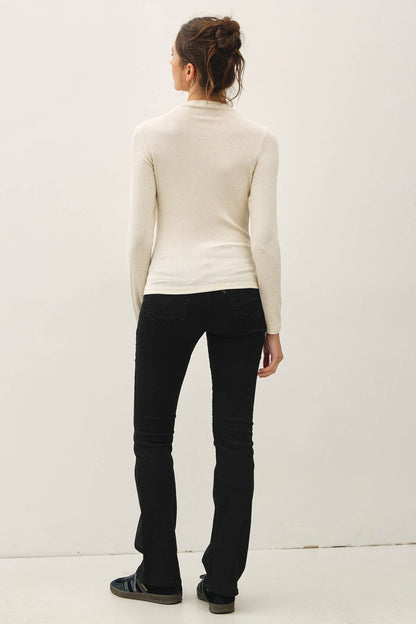 Cream ribbed mockneck long sleeve knit top, slim fit, worn with black flare pants