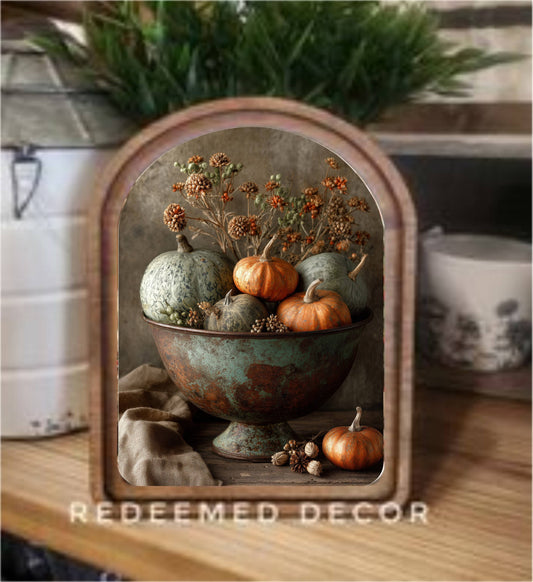 Framed canvas art of orange pumpkins in rustic teal bowl with dried florals