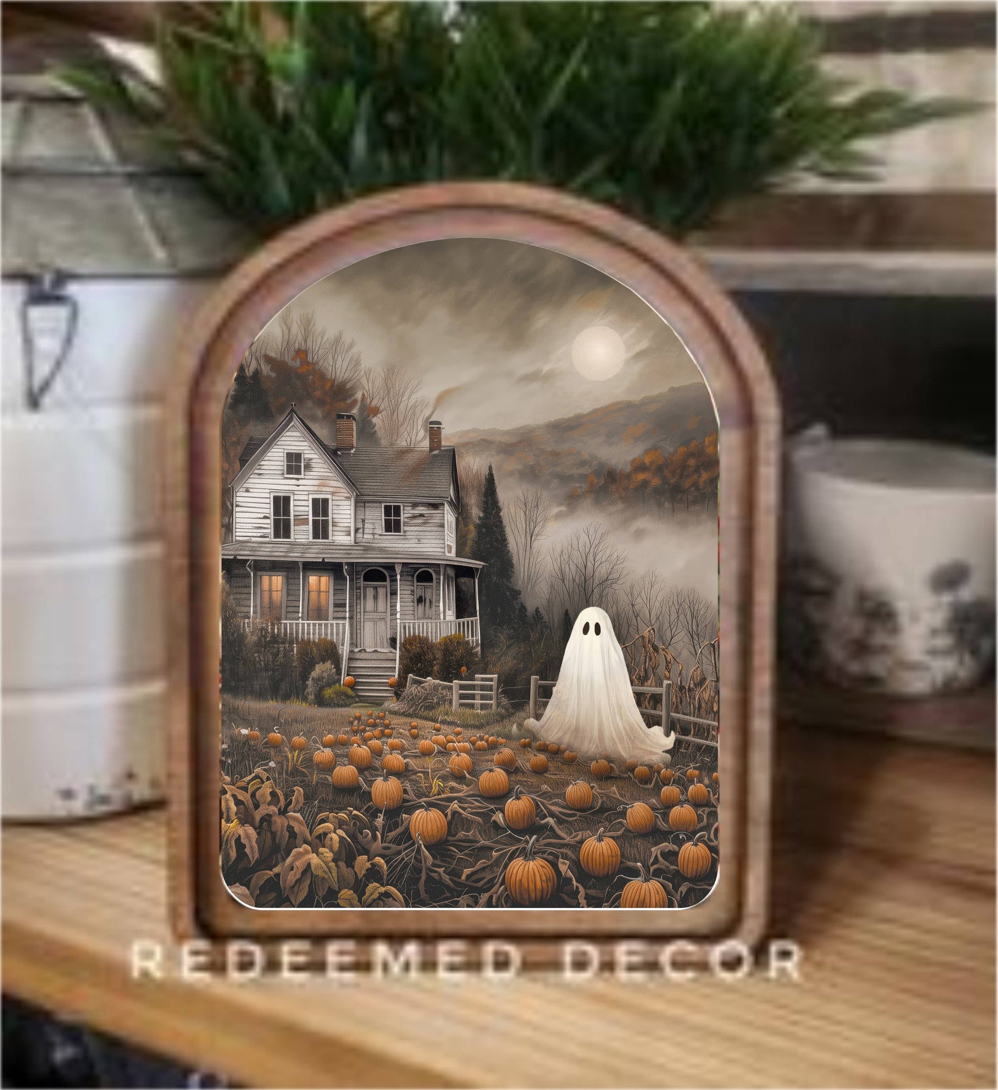 Arched wood-framed Halloween art print with ghost, pumpkin patch, and spooky farmhouse