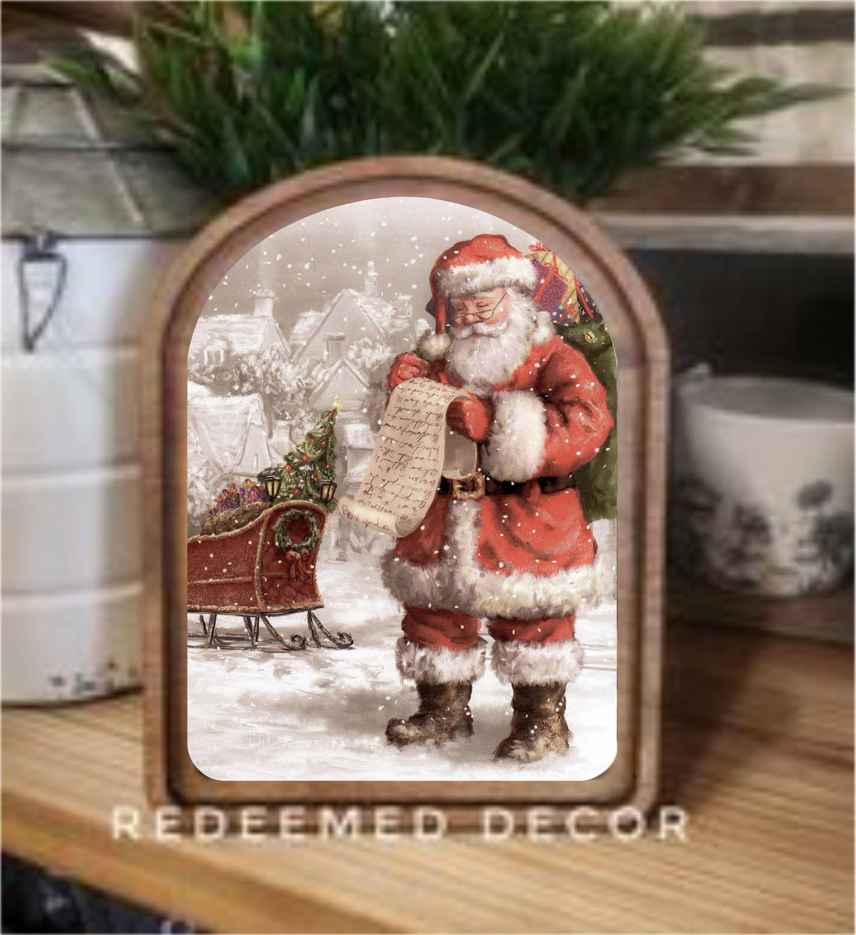 Arch-top wood framed canvas print of vintage Santa reading list in snow