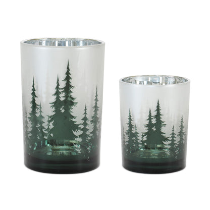Two green frosted glass candle holders with pine tree silhouette design, silver interior