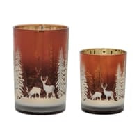 Two copper brown glass candle holders with white winter deer and pine tree scene