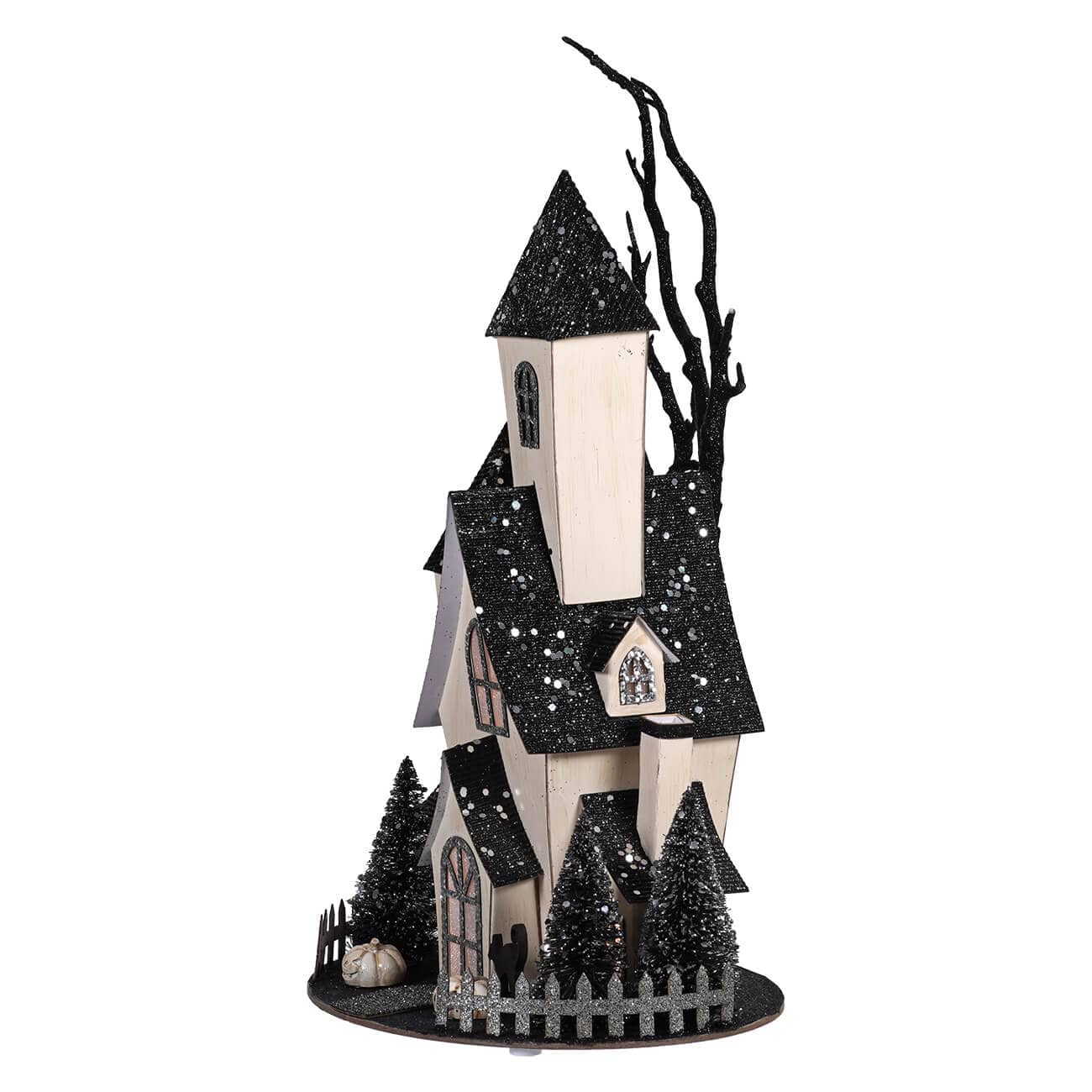 Tall cardboard haunted house decoration with black glitter roofs, bare tree, and miniature fence on round base
