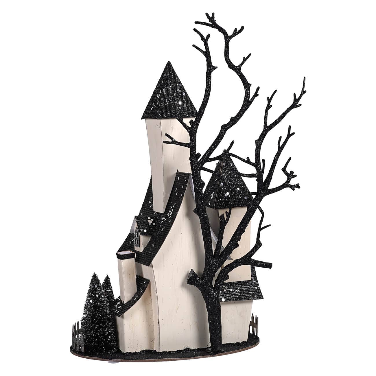 Cardboard haunted house decoration with black glitter bare tree, multiple towers, and miniature evergreen trees