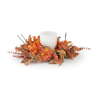Fall candle ring with orange florals, berries, and dried leaves around white pillar candle