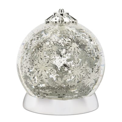 Silver and clear rotating snowflake snow globe 6.5 inches tall on white base