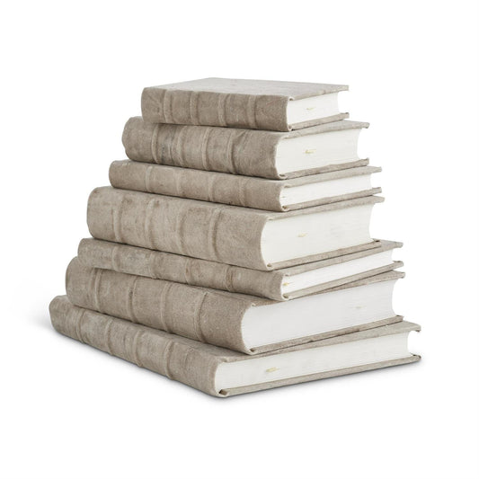 Stack of six antiqued beige cotton canvas hardcover journals in graduated sizes
