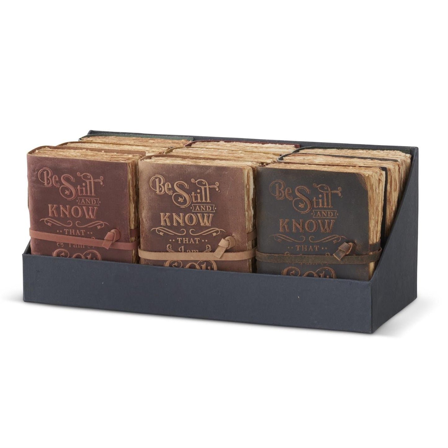 Three leather embossed Be Still And Know journals in brown, tan, and dark gray