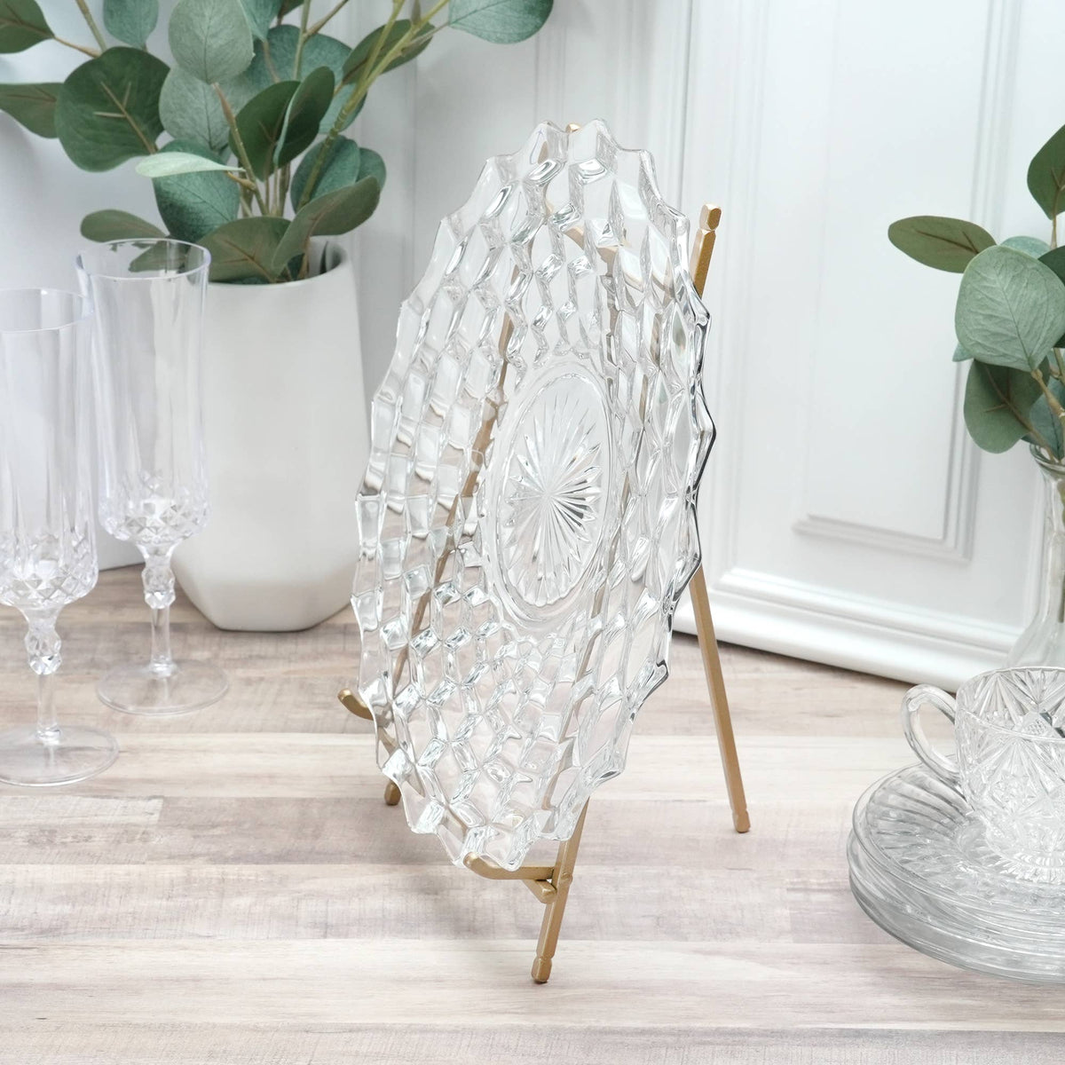 Gold satin metal easel stand displaying a clear crystal decorative plate, 12 inches tall