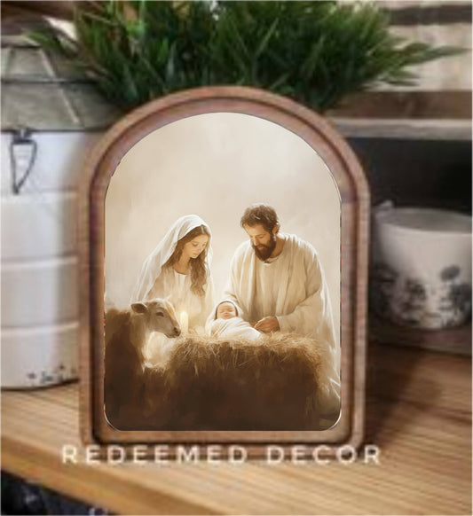 Arch-framed nativity canvas art with Mary, Joseph, and baby Jesus in manger