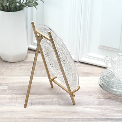 Gold satin metal easel stand displaying a clear cut glass decorative plate