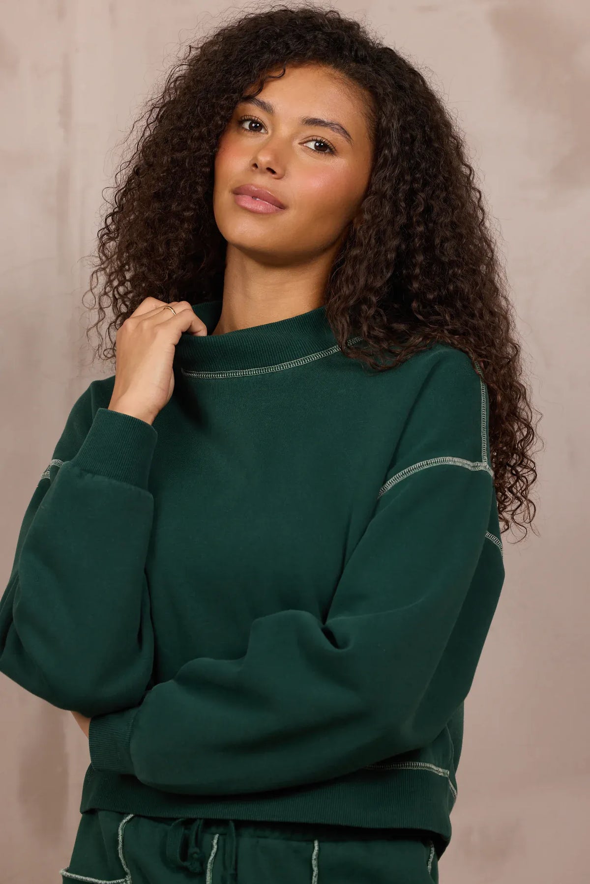 Forest green mockneck sweatshirt with contrast stitching and relaxed fit