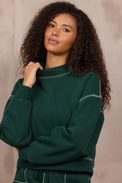 Forest green mockneck sweatshirt with contrast stitching and relaxed fit