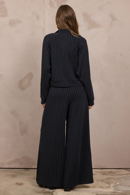 Navy pinstripe raglan zip-up jacket with matching wide-leg trousers, back view