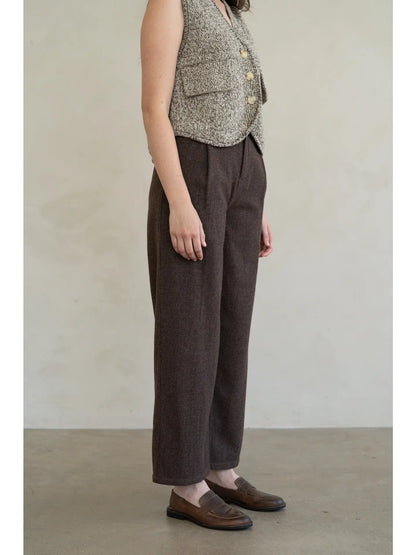 Dark brown houndstooth wide-leg cropped trousers with front pleats and loafers