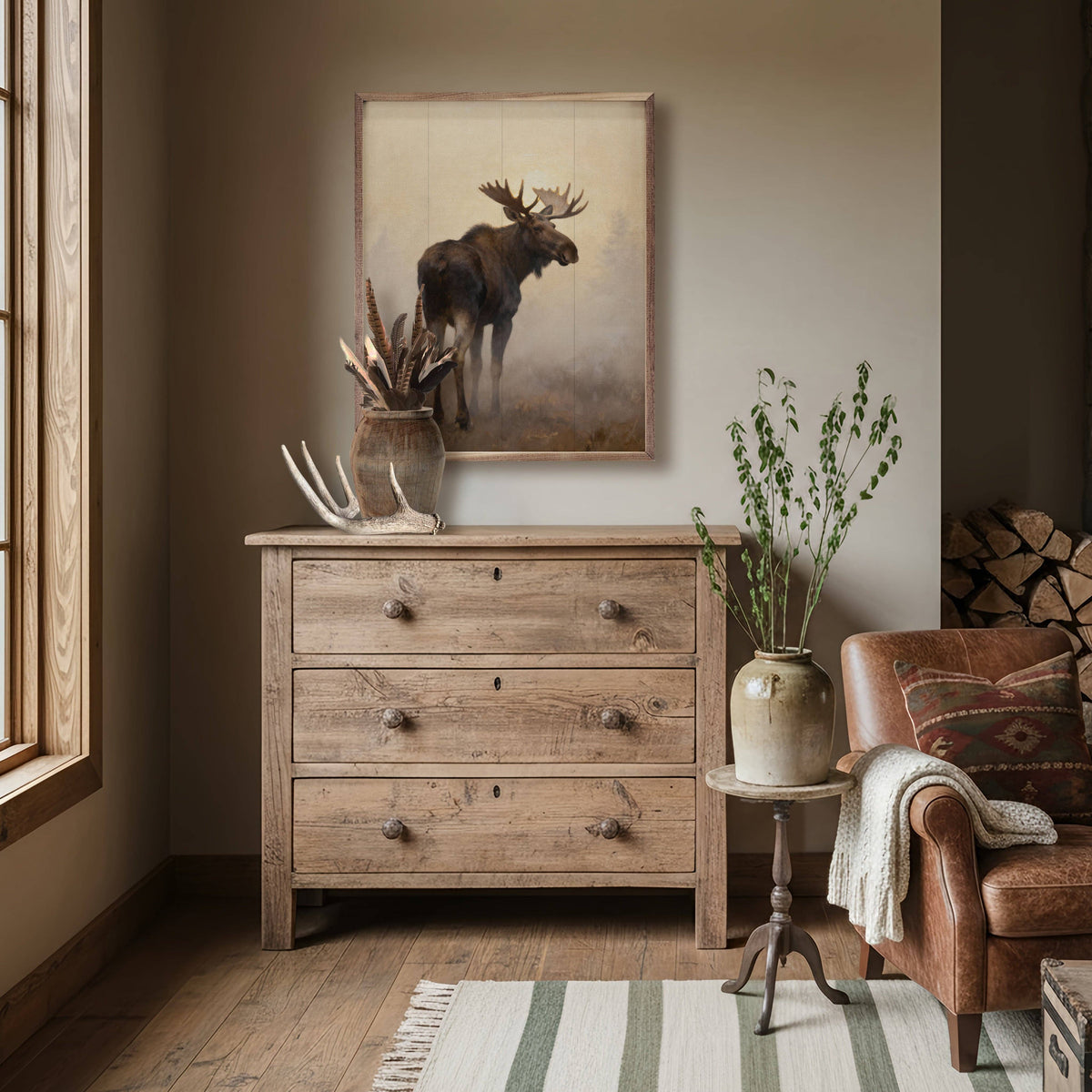 Framed moose painting in misty neutral tones, displayed above rustic wood dresser