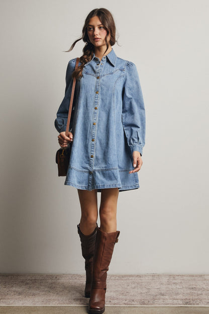 Light wash denim mini shirt dress with snap buttons, puff sleeves, and Western yoke detailing