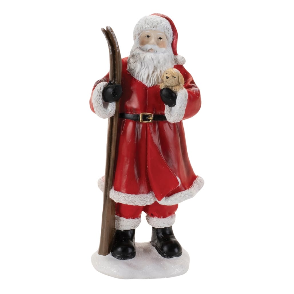 Resin Santa Claus figurine holding wooden skis and a small puppy, standing on snow base