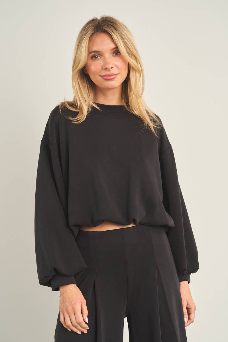 Black cropped crewneck sweatshirt with oversized balloon sleeves and ribbed cuffs