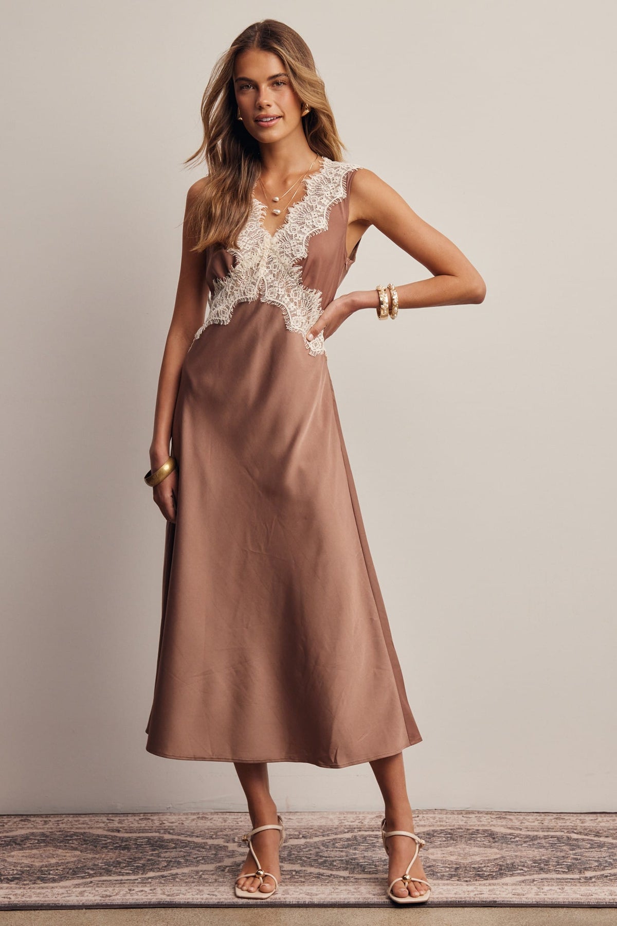 Brown satin midi dress with ivory lace trim neckline and bodice, sleeveless V-neck