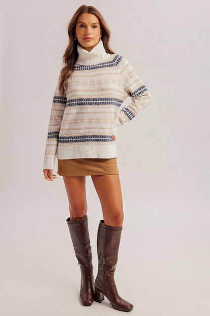 Cream Fair Isle turtleneck sweater with blue and tan stripe pattern