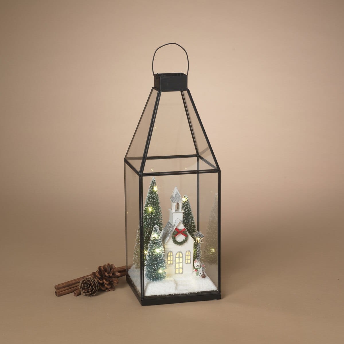 Black metal glass lantern with lighted winter village church scene and miniature trees