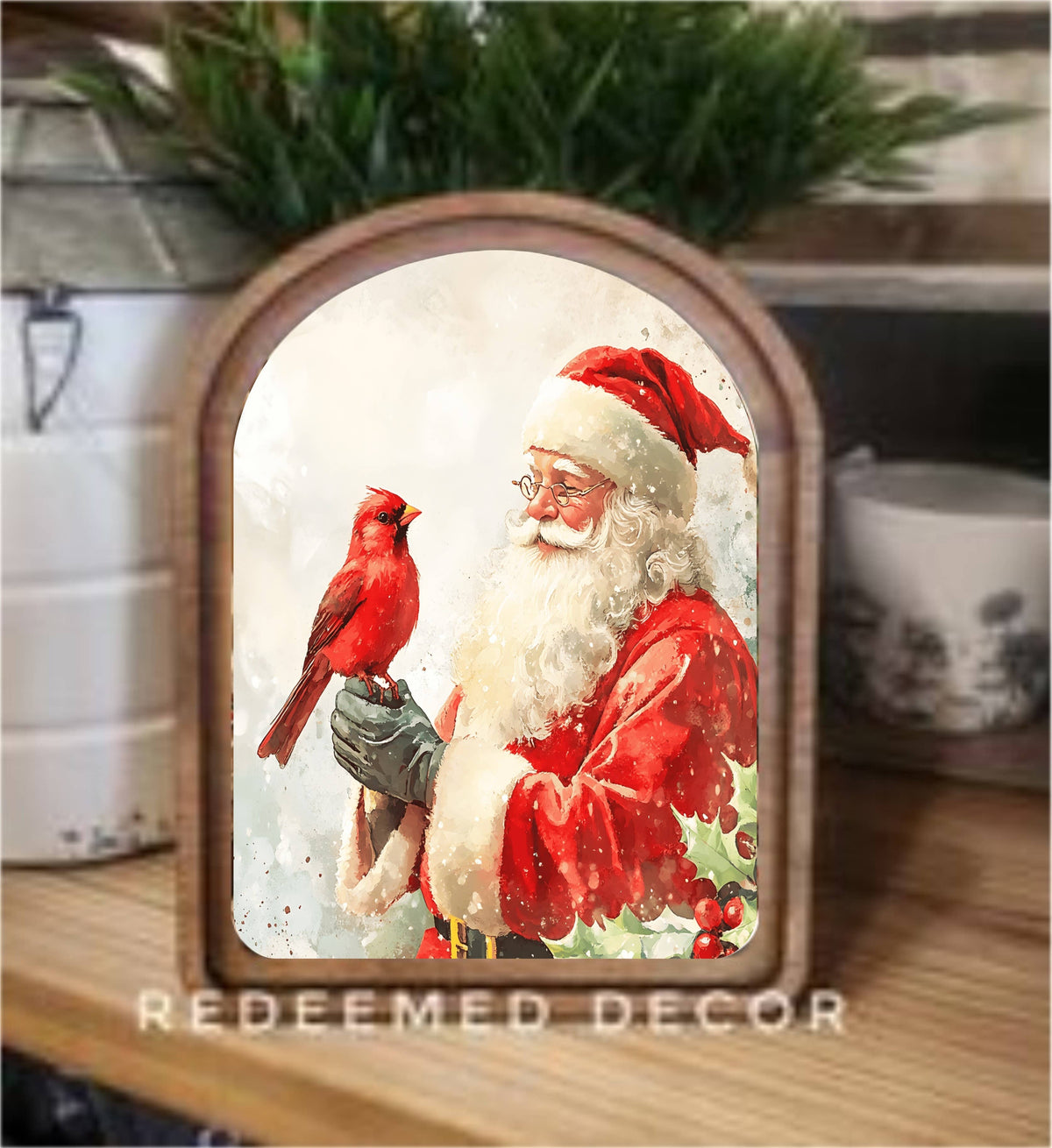 Arch-framed Santa Claus holding a red cardinal, wood frame, shelf decor