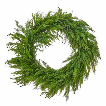 Large round cedar and Norfolk pine wreath with lush, cascading green foliage on white background