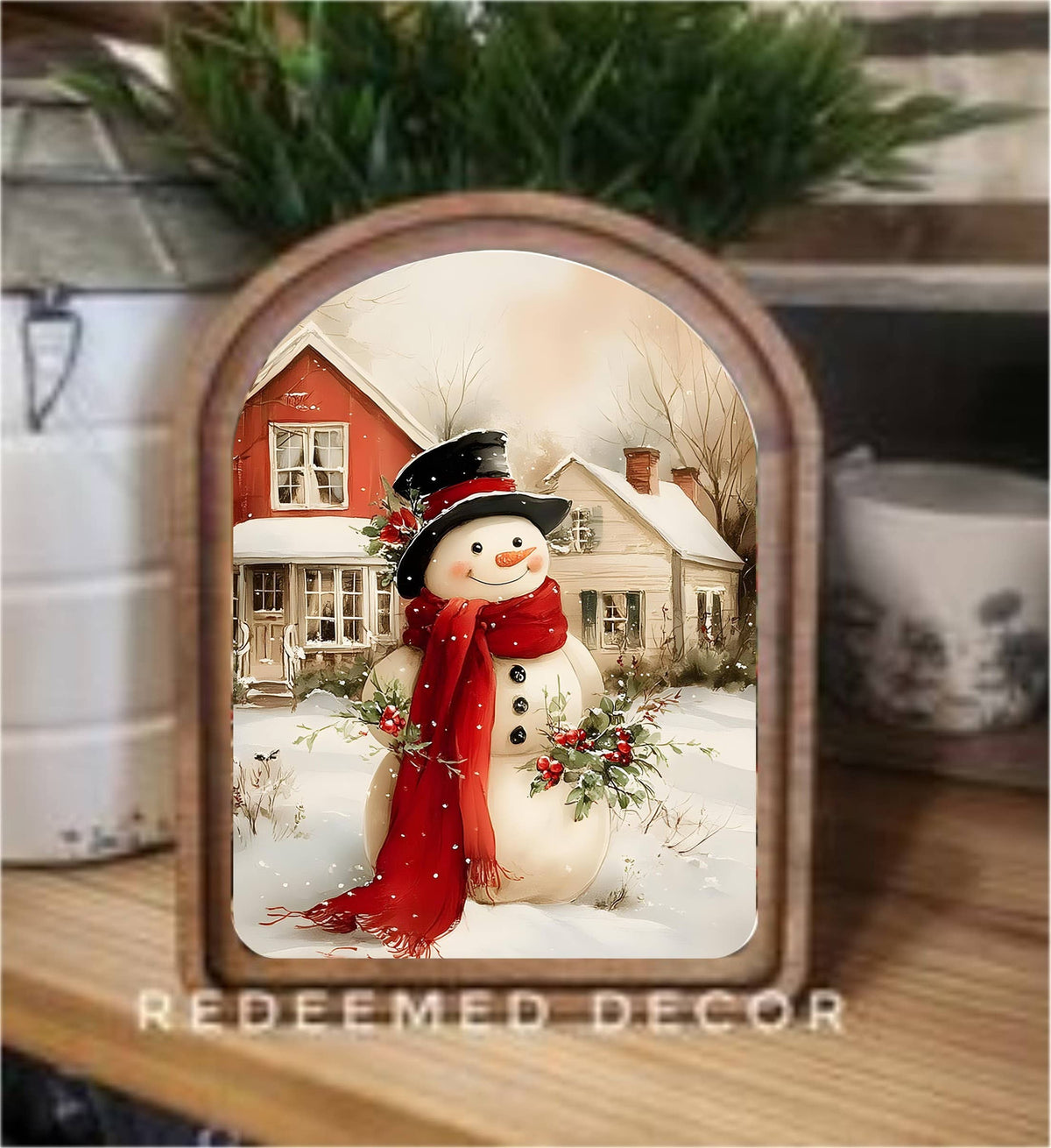 Arched wood-framed canvas art featuring a smiling snowman with red scarf and black top hat