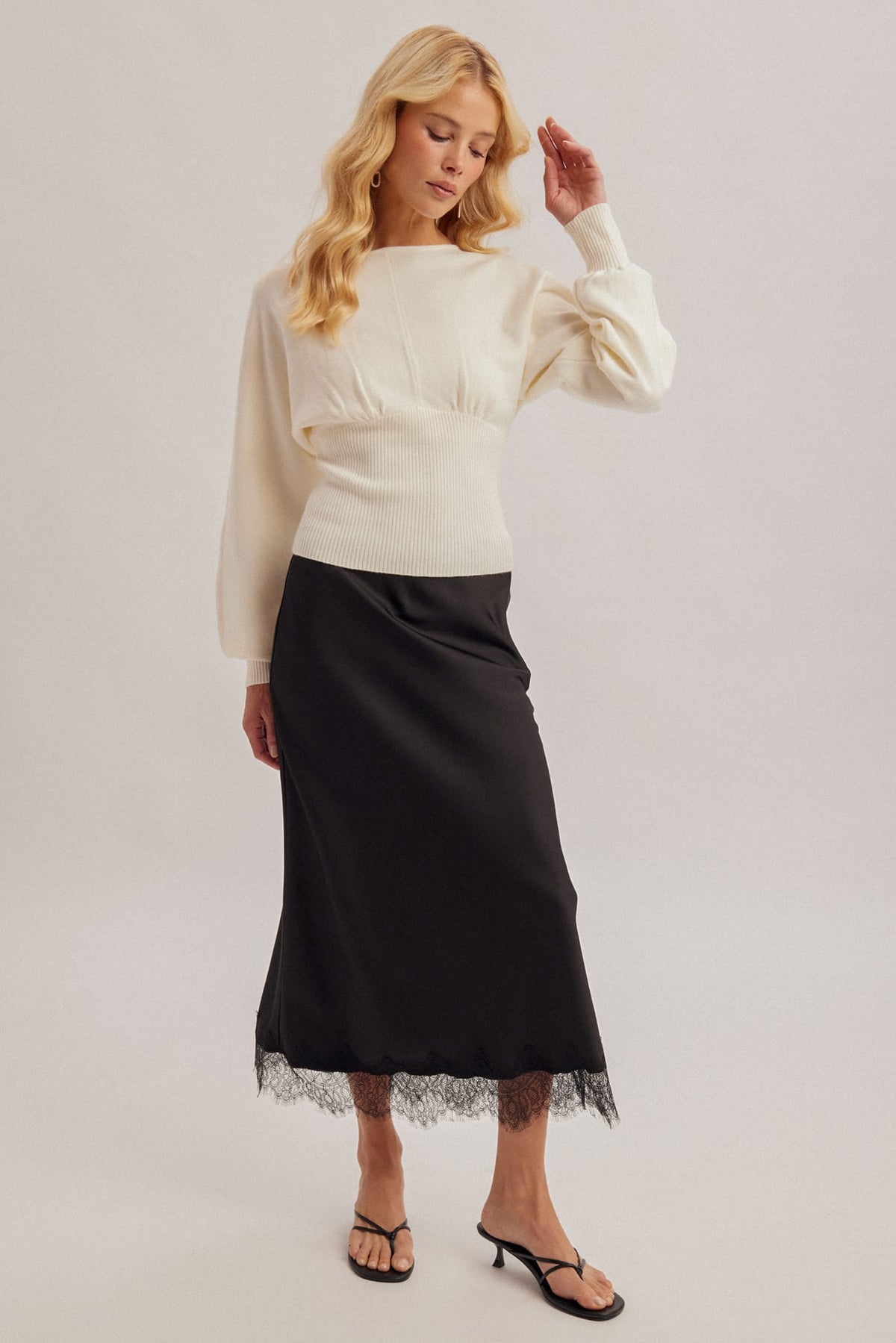 Black satin midi skirt with lace hem trim, elasticized waist, smooth lustrous finish
