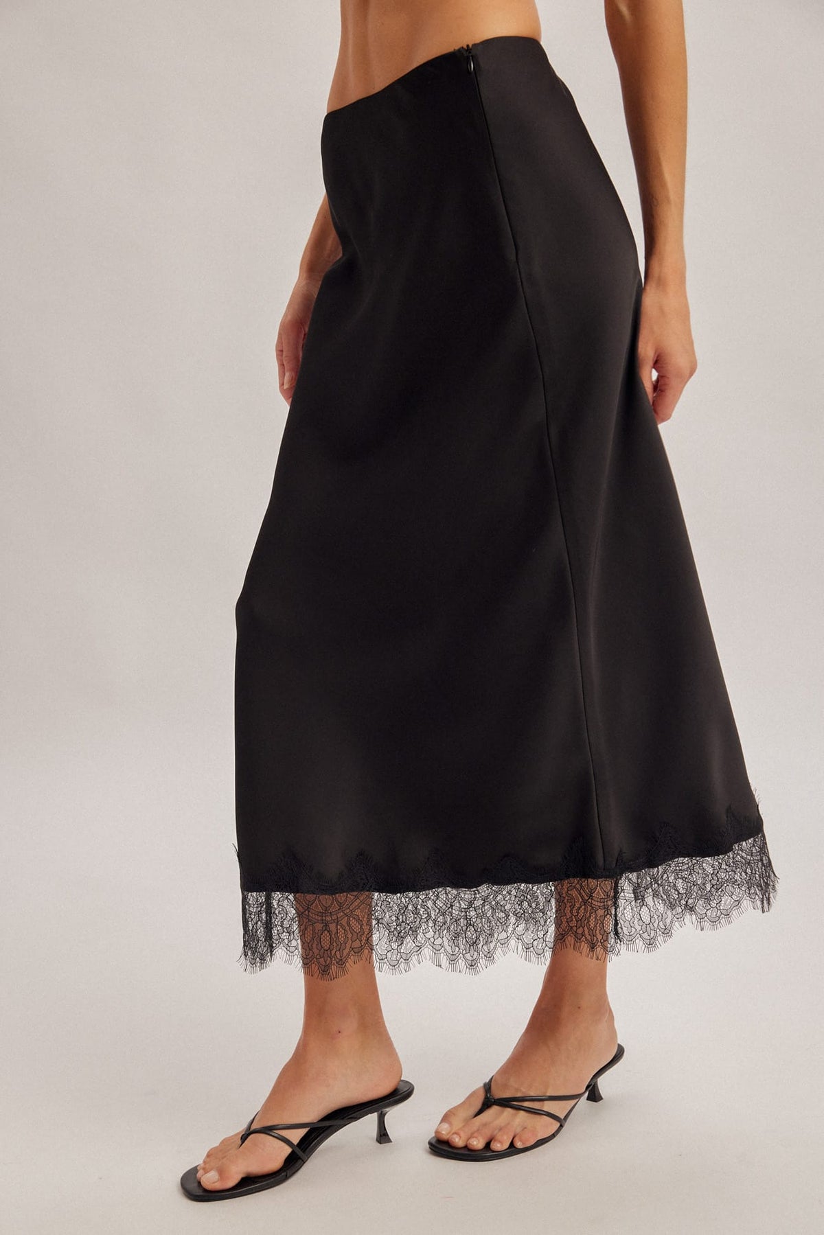 Black satin midi skirt with delicate lace hem trim and back zipper closure