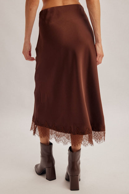 Chocolate brown satin midi skirt with lace hem trim, worn with brown boots