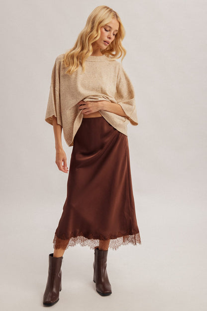 Chocolate brown satin midi skirt with lace hem trim, worn with beige sweater