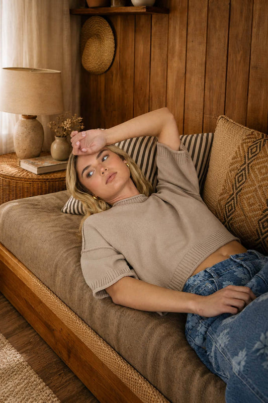 Taupe knit crop pullover with drop shoulders, exposed seams, and short sleeves