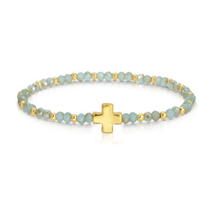 Mint crystal and gold bead stretch bracelet with gold balanced cross centerpiece