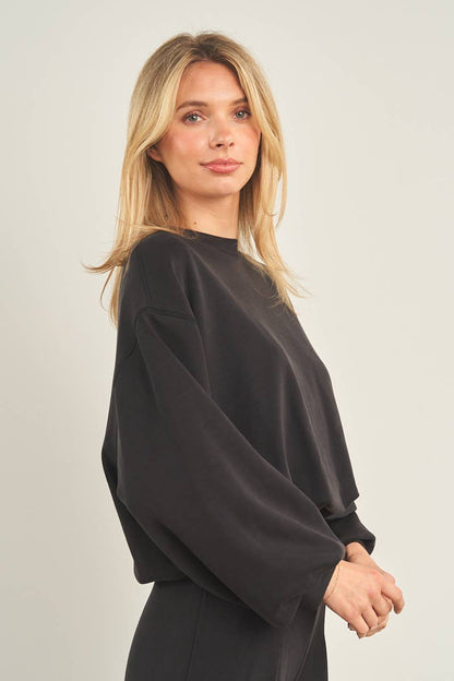 ANWND cropped black crewneck sweatshirt with wide sleeves and ribbed cuffs