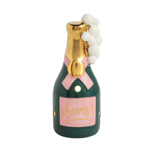 Green ceramic champagne bottle sitter with gold neck, pink bow label, and white bubbles