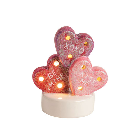 Glitter heart candy sitter with LED lights reading XOXO Be Mine Kiss Me on white base