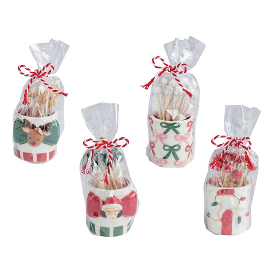 Four Christmas ceramic toothpick caddies in cellophane bags: reindeer, Santa, bows, and stockings