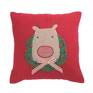 Red knit throw pillow with reindeer and Christmas wreath appliqué design