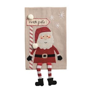 Santa Claus dangle leg decorative towel with North Pole sign on tan linen background
