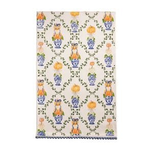 Cream kitchen towel with blue vases, orange pumpkins, foxes, and vine lattice pattern